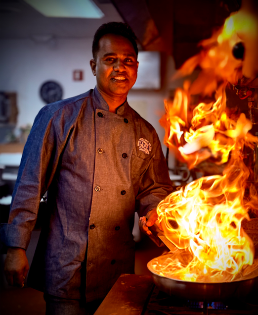Chef Thushara Siriwardana cooking over open flame