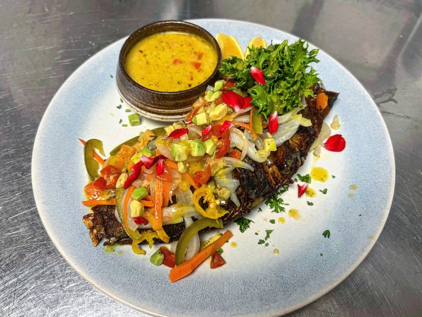 Whole fresh-caught snapper, plated, herbs and citrus